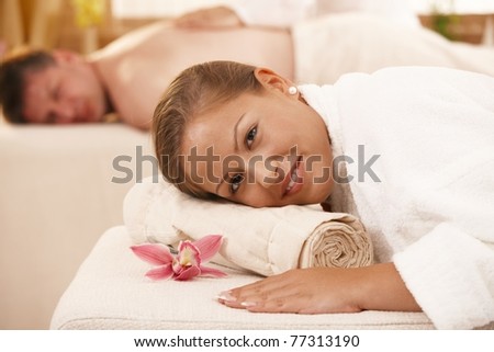 Relaxed couple lying on massage bed in day spa.?