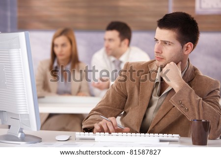 Young man sitting at training course, using computer.?