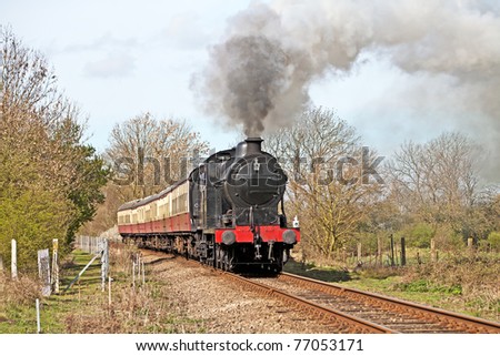 Steam train on a gentle day out with passengers on-board
