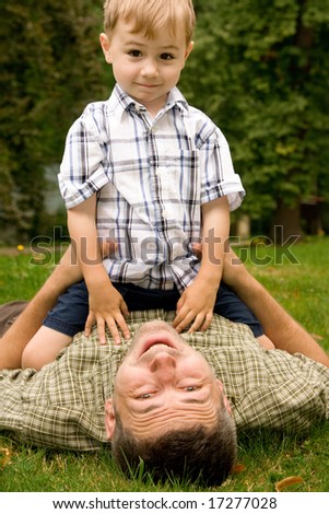 Father and son playing together in the garden.