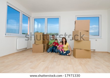 Family with moving boxes in new home.