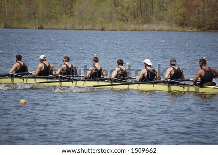 An 8-man crew team pulls together toward the end of their race
