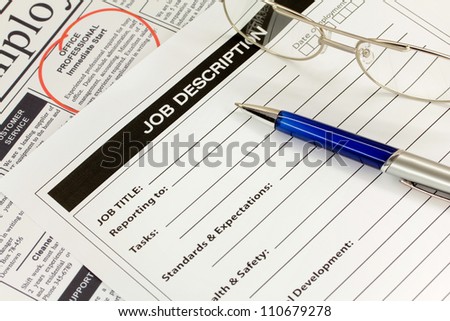Job Description with Pen and Newspaper Ad