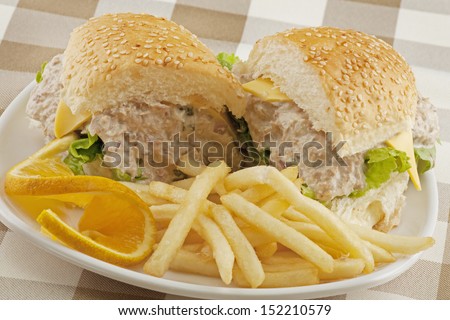 A delicious tuna salad sandwich with french fries
