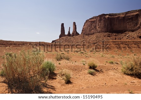 The Three Sisters rock formation in Monument Valley Navajo Tribal Park located on the southern border of Utah with northern Arizona.