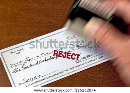 A stamp is used to mark a personal check reject