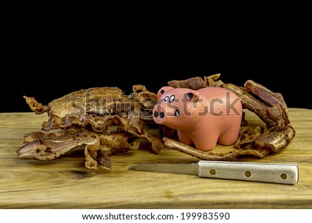 Toy pig with cooked bacon
