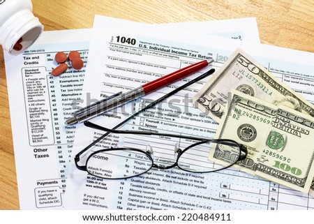 Federal tax forms with asprin and money