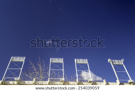 Football stadium lights and blue sky
