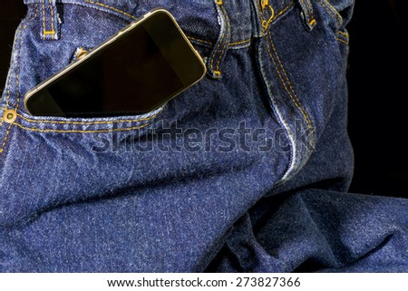 Blue denim jeans with a smart phone in the pocket
