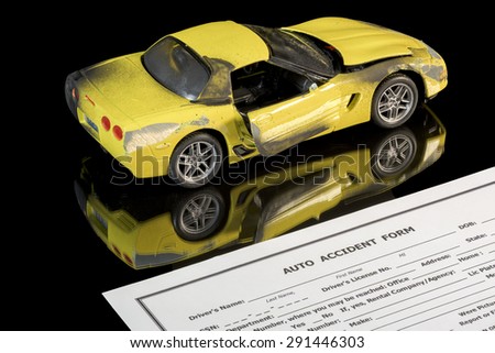 Beat up toy car and auto insurance claim form