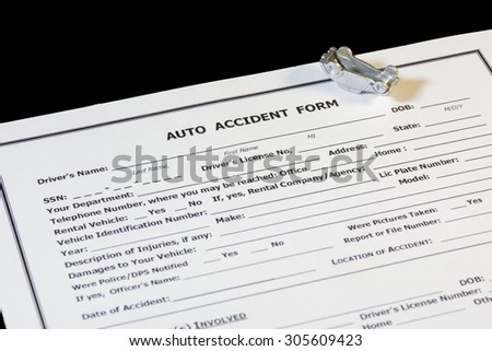 Auto Accident form with toy car upside down