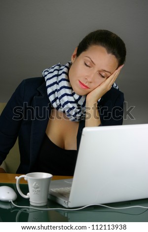Tired woman sleeping at office