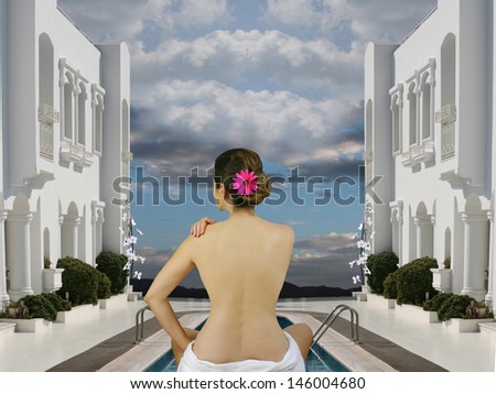 Spa wellness woman sitting with a bare back in a towel in a white hotel and relax