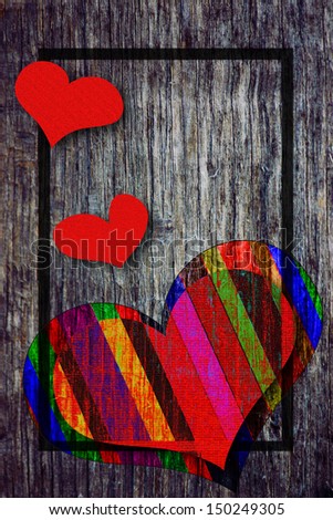 Old wood board with striped heart on it, background valentine