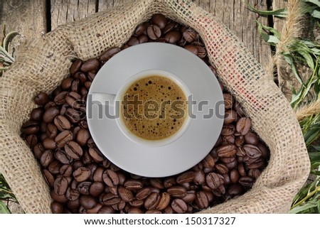 Sack of coffee beans and a cup of coffee vintage