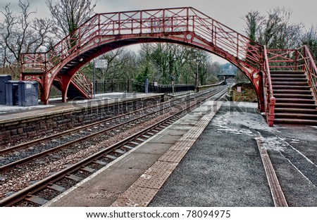 Old English railway station platform bridge and lines