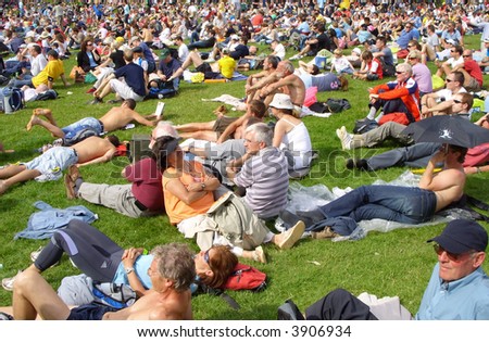 Summer concert crowd relaxing at hyde park London.