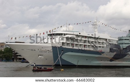 LONDON-SEPT 11; A passenger liner visits londons river thames and docks alongside the battleship h.m.s belfast, during the annual festival of London, Sept,11, 2010, which was visited by 1000s.