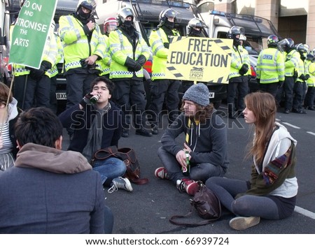 LONDON - DEC 9: Students demonstration against university fee rises in front of police lines at the houses of parliament buildings London, dec 9, 2010.