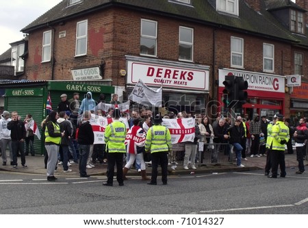 LONDON - FEB 12: English defence league protesters demonstrate behind police lines, against londons latest mosque being built at Dagenham, london, feb 12, 2011.