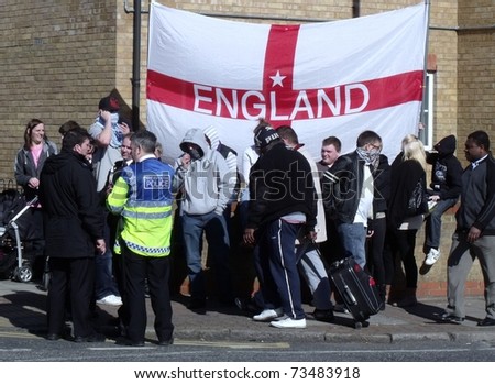 LONDON- MARCH 19: English defense league protesters demonstrate behind police lines, against London\'s latest mosque being built in Dagenham on March 19, 2011 in London.