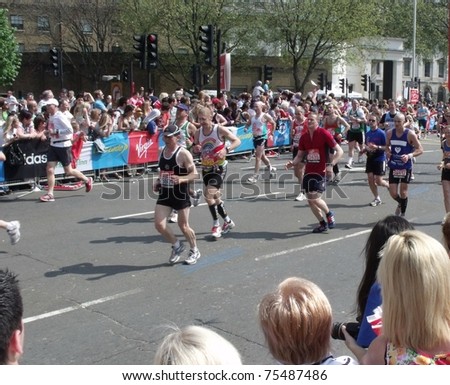 LONDON- APRIL 17: Crowds cheering the virgin 2011 London marathon runners, at tower bridge, London, april 17, 2011.