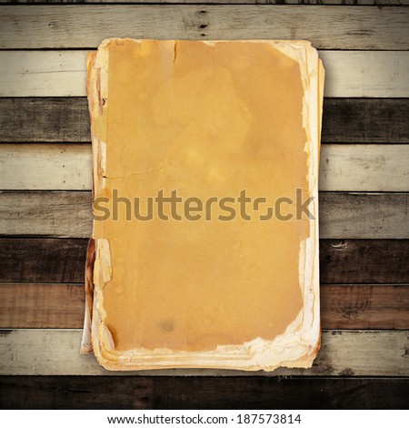 Vintage book on wooden background, with clipping path.