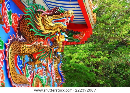 Chinese dragons statue on the wall background.