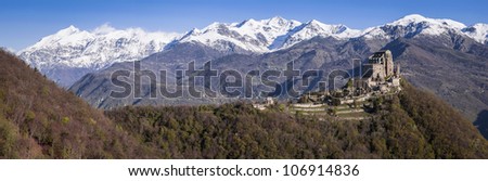 Panoramic shot of Saint Michel Abbey with snowed Alps mountain range beside (14021 x 4568 pixels). Piedmont, North West of italy