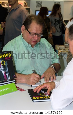 WARSAW, POLAND - MAY 18: Ryszard Kalisz signs his book on the Fourth Book Fair held at the National Stadium on May 18, 2013 in Warsaw