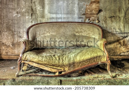 Rotten sofa in an abandoned house