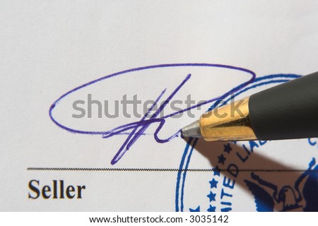 Signature and a pen on contract with a stamp