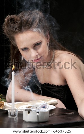 Alone smoking woman sits in restaurant. Studio shot