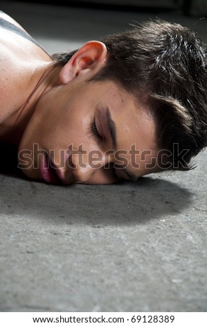 Man laying down on the floor after fight