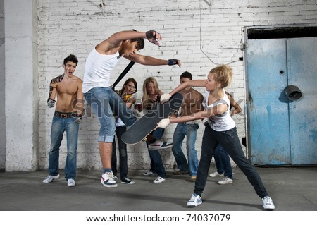 Street fight, woman beating man with skateboard