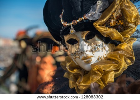 Golden Venetian Carnival Mask Wonderful mask participant of the carnival celebrations in St. Mark\'s basin. Blurred background.