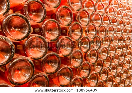 A row of champagne bottles - Wine cellar Bottles of wine stocked in a wine cellar.
