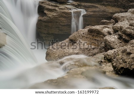 Waterfall with long exposure, ND filter, 10 stops, used, three different states of water, browny color of rocks