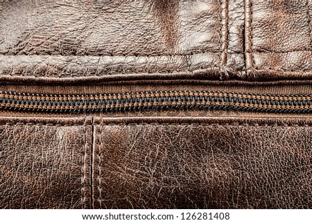 Closeup of leather texture with zip closure for art design.