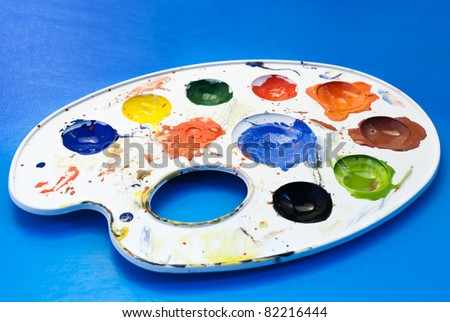 A  palette of colorful paint samples on a blue background.