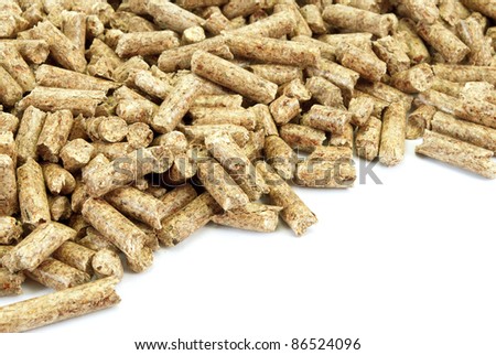 Fragment of  big pile of wood pellets, isolated on white.