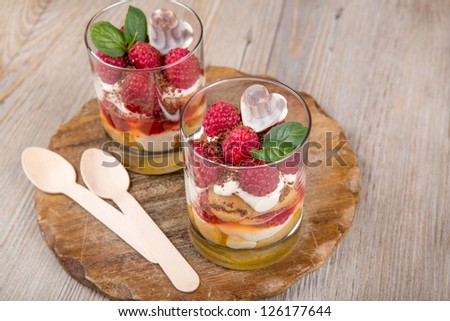 Sweet dessert tiramisu with fresh raspberry, cream and mint