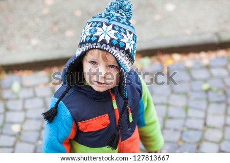 Portrait of little toddler boy in spring clothes, outdoors.