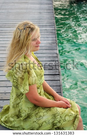 Young woman on wooden landing stage on Maldivian island