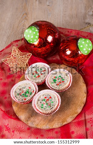 Christmas dessert: Mini cookies and cream cheesecakes in muffin forms with red Christmas tree balls