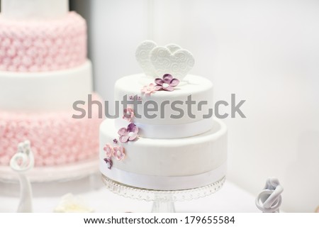 Delicious beautiful wedding cake in white , creme and pink.