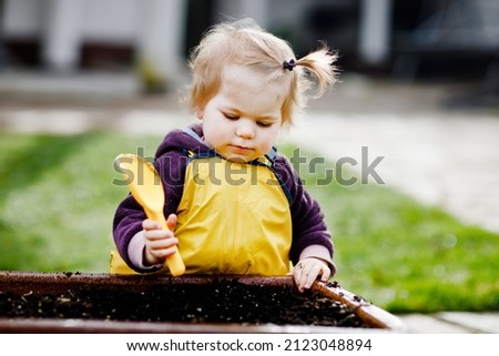 Similar – Image, Stock Photo Adorable toddler girl playing with beach on white sand beach