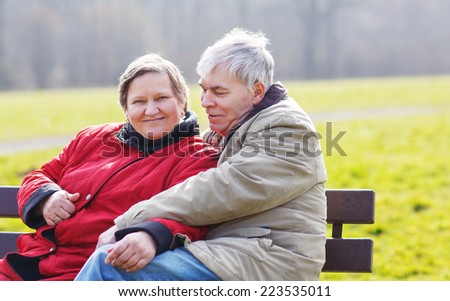 Happy senior couple in love. Park outdoors. in spring on cold day