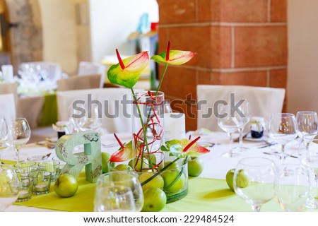 Elegant table set in white and green with apples for wedding or event party in a castle